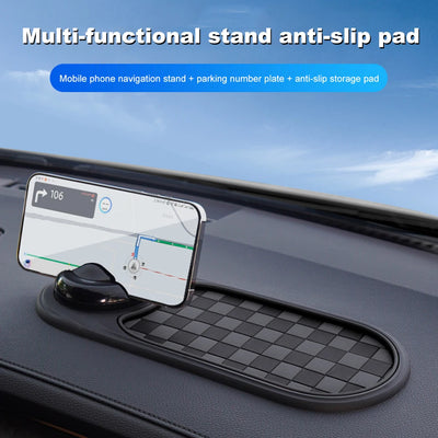 Multi-functional stand anti-slip pad on a car dashboard with phone and number plate holder.